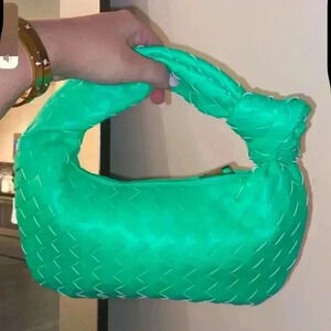 Neon green braided knot clutch bag